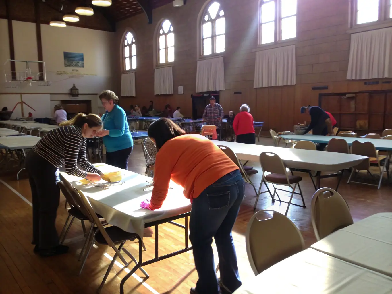 An image showing volunteers setting up for a community event, highlighting the collaborative effort and dedication of GAAC members.